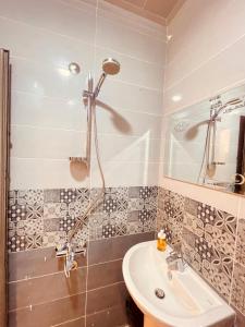 a bathroom with a sink and a shower at El mansour hotel apartmen 72 in Mansoura