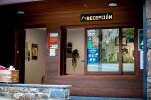 a reflection of a person in the window of a store at Camping Valle de Bujaruelo in Torla-Ordesa