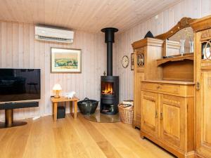 a living room with a wood burning stove in it at Holiday home Padborg in Padborg