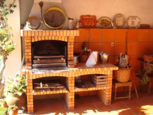 a brick oven in the middle of a kitchen at Casa Rural Oliveira do Bairro in Oliveira do Bairro