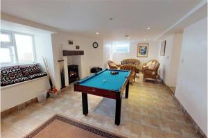 a living room with a pool table in it at Afallon Aberdaron in Aberdaron