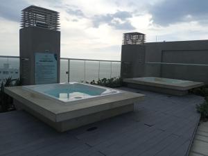 two hot tubs on top of a building with the ocean at ReservaMar in Gaira
