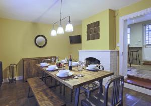 a dining room with a table and a fireplace at 4 Lambseth Street in Eye