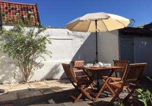 a table and chairs with an umbrella on a patio at 4 Lambseth Street in Eye
