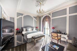 a bedroom with a king sized bed and a window at Bentley London in London