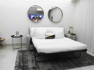 サンティアゴ・デ・ロス・カバリェロスにあるSoha Panorama B13 King Bed High Floor Balcony Viewのベッドルーム1室(鏡付きのベッド1台、ラグ付)