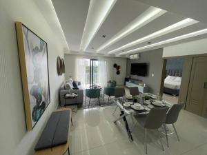 a living room with a table and chairs and a couch at Soha Panorama B13 King Bed High Floor Balcony View in Santiago de los Caballeros