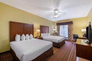 a hotel room with two beds and a flat screen tv at Best Western Plus Gadsden Hotel & Suites in Gadsden