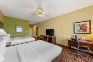 a hotel room with two beds and a desk and a tv at Best Western Plus Gadsden Hotel & Suites in Gadsden