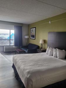 a hotel room with a large bed and a couch at Best Western Kent Narrows Inn in Grasonville