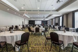 a conference room with tables and chairs and a screen at Best Western Plus Dartmouth Hotel & Suites in Halifax +57 photos