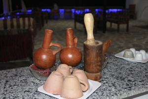 a group of vases sitting on top of a table at Artika Wadi Kiki Hotel in Aswan