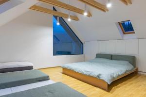 a bedroom with two beds and a large window at CUBE Bucin in Bucsin