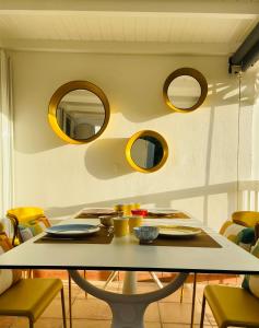 a dining room with a table and mirrors at Le Rocher in Gustavia