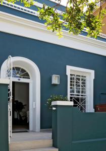a building with a blue wall and a doorway at Waterkant House - 151 in Cape Town