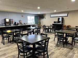 a restaurant with tables and chairs in a room at Super 8 by Wyndham Escanaba in Escanaba
