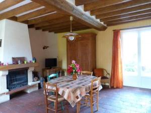 a dining room with a table and a fireplace at Gîte Saint-Rémy-de-Sillé, 6 pièces, 8 personnes - FR-1-410-150 in Saint-Rémy-de-Sillé