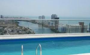 a large swimming pool with a view of a city at Exclusive House Cartagena in Cartagena de Indias
