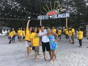 a group of people posing for a picture on the beach at Puerto Silanguin Beach Camping Resort in Zambales