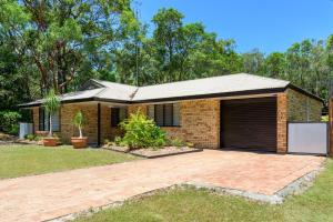 a brick house with a garage at 13 Orania Court in Rainbow Beach