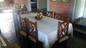 a white table with chairs and a vase of flowers on it at Casa com piscina em Gravatá PE in Gravatá +12 photos