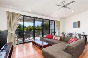 a living room with a couch and a table at Rainbow Surf 2 in Rainbow Beach