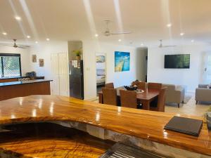 a kitchen and a living room with a table at Sandys On Cypress in Rainbow Beach