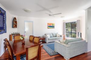 a living room with a table and a dining room at Mortimer in Rainbow Beach