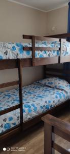 a bedroom with three bunk beds with blue flowers at La Serena vista al mar in La Serena