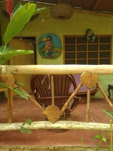 a dolls house with a porch with a chair in it at ECO Hostal Monolandia in El Zaino