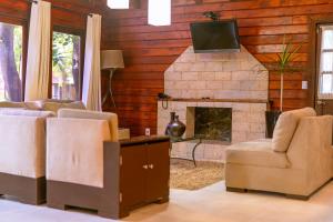 a living room with a couch and a fireplace at Santa María Resort in Santa María del Oro