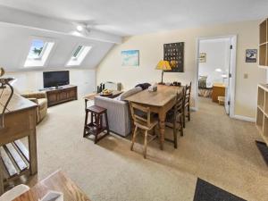 a kitchen and living room with a table and a couch at Sugarbush Summit Condo in Warren