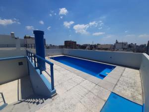 a swimming pool on the roof of a building at Alto Palermo in Buenos Aires