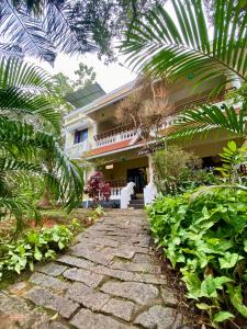a stone walkway in front of a house at Mango Villa in Varkala