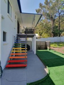a stairway leading to a house with a lawn at Rainbow Stairs in Rainbow Beach