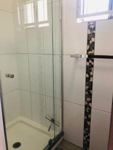 a bathroom with a shower with a glass door at Rainbow Stairs in Rainbow Beach