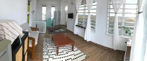 a living room with a table and a couch at Bendang Homes - Sekinchan Homestay in Kampong Sungai Leman