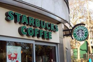 a starbucks coffee sign on the front of a store at Trendy Windermere Condo, AirCon, Top Floor, King Bed, Secure UG Parking, BBQ! in Edmonton