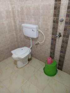a bathroom with a toilet in a tiled room at Goroomgo Star Inn Digha Near Sea Beach - Lift & Parking Facilities - Best Seller in Digha