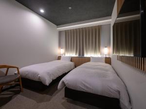 Letto o letti in una camera di Hotel Tsu Center Palace