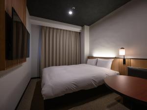 Letto o letti in una camera di Hotel Tsu Center Palace