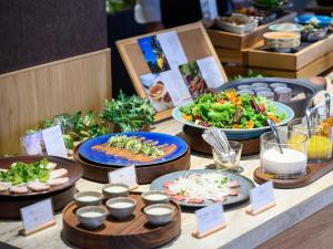 a buffet with plates of food on a table at Hotel Tsu Center Palace in Tsu