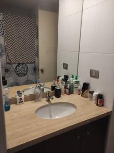 a bathroom counter with a sink and a mirror at Valparaiso Rental in Valparaíso