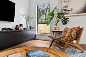 a living room with a chair and a table at McMillan Escape in Anglesea