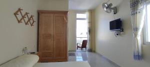 a room with a bed and a tv and a door at Homestay Dalat Xinh in Da Lat +46 photos