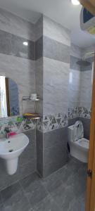 a bathroom with a sink and a toilet at Homestay Dalat Xinh in Da Lat