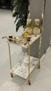 a gold cart with plates and vases on it at قولد تاور in Khamis Mushayt