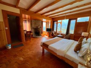 a bedroom with a bed in a room with a fireplace at Valley of god in Manāli
