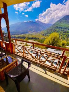balcone con tavolo, sedia e montagne di Valley of god a Manāli