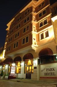 a building with a park hotel at night at Oglakcioglu Park Boutique Hotel in İzmir